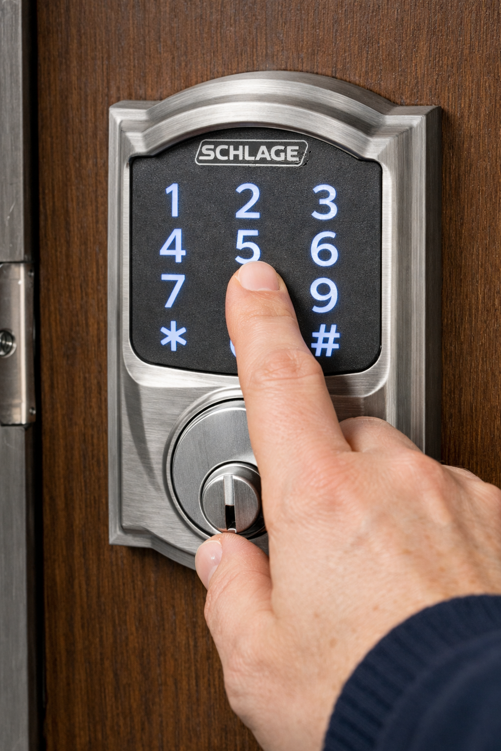 Hand entering code on a Schlage keypad lock
